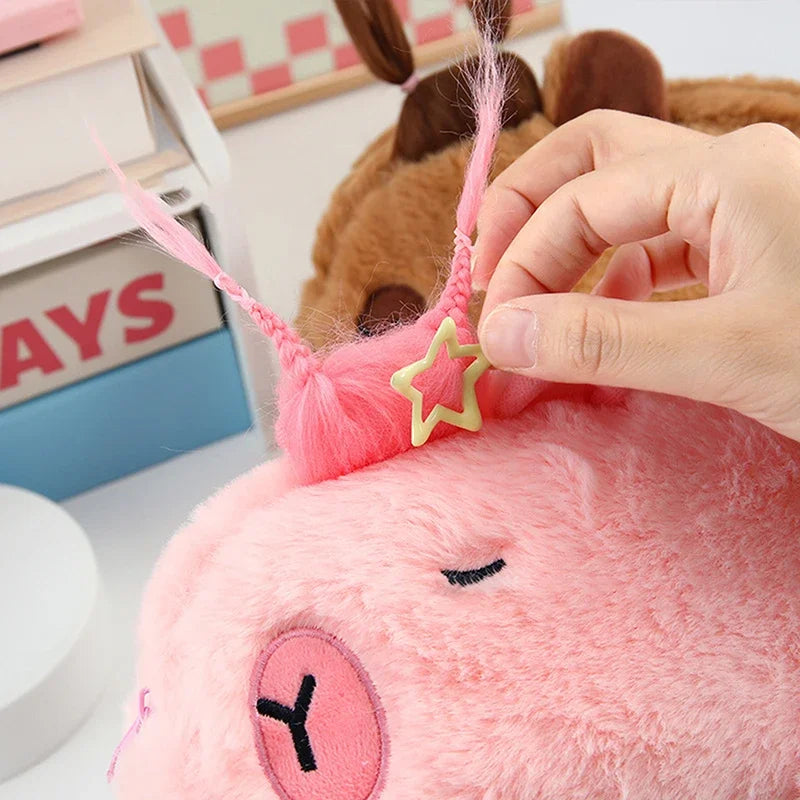 Pink kawaii plush toy with a star on its head, being adjusted by a hand.