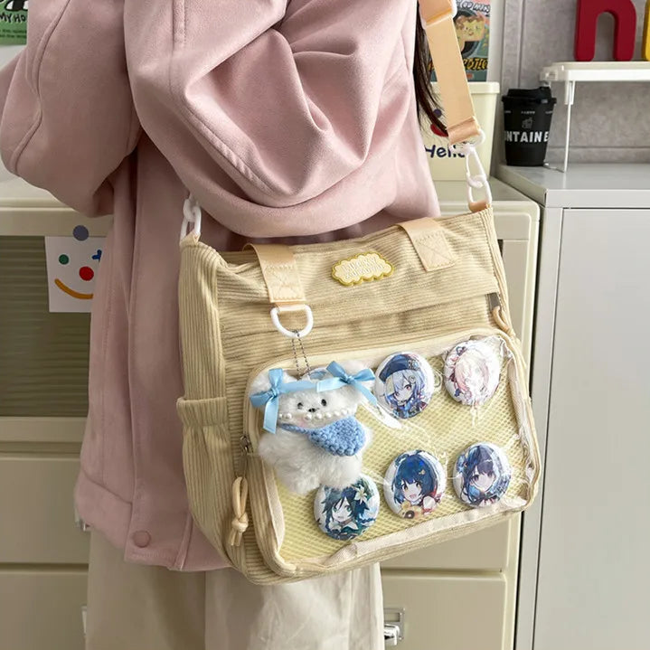 Person wearing a beige Kawaii bag with character designs in an indoor setting