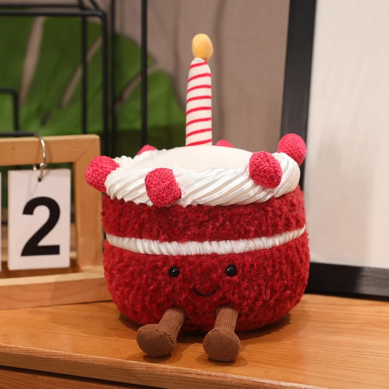 Knitted red cake kawaii toy with a candle on a wooden surface