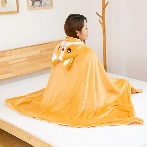 Person wearing a yellow kawaii animal-themed blanket draped over their shoulders in a bedroom setting.