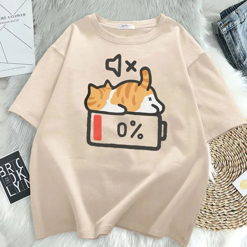 Beige t-shirt with a kawaii graphic of a cat and battery icon on a light gray surface.