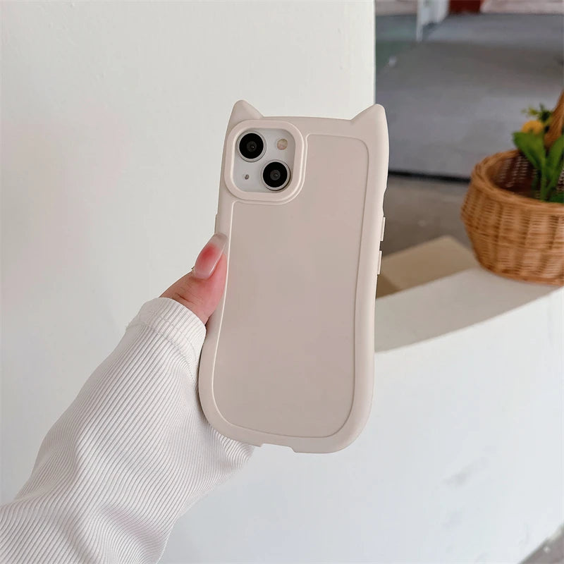 Beige kawaii phone case with cat ears held by a hand against a neutral background