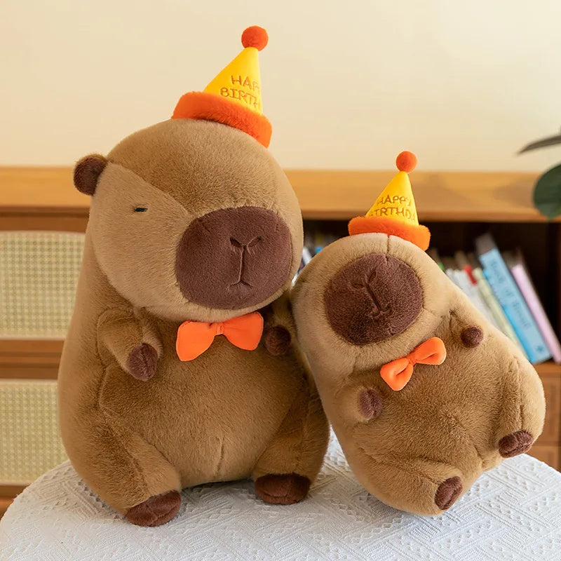 Two brown kawaii teddy bears wearing party hats and bow ties on a white surface.