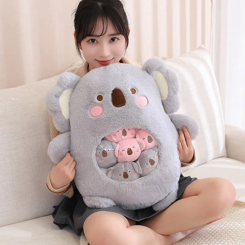 Person holding a large koala-shaped kawaii pillow on a couch