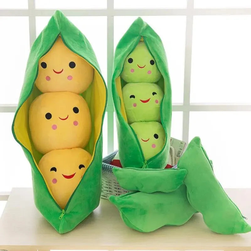 Kawaii plush toys shaped like peas in a pod with smiling faces on a white surface.