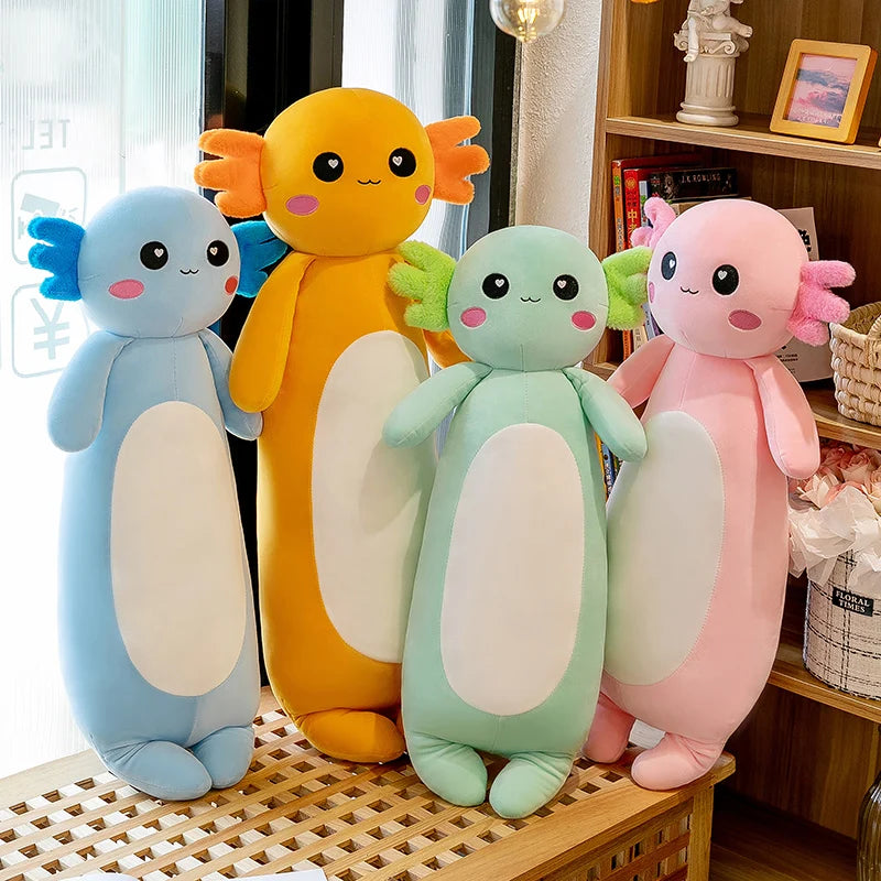 Four colorful kawaii plush toys on a wooden surface with a blurred indoor background