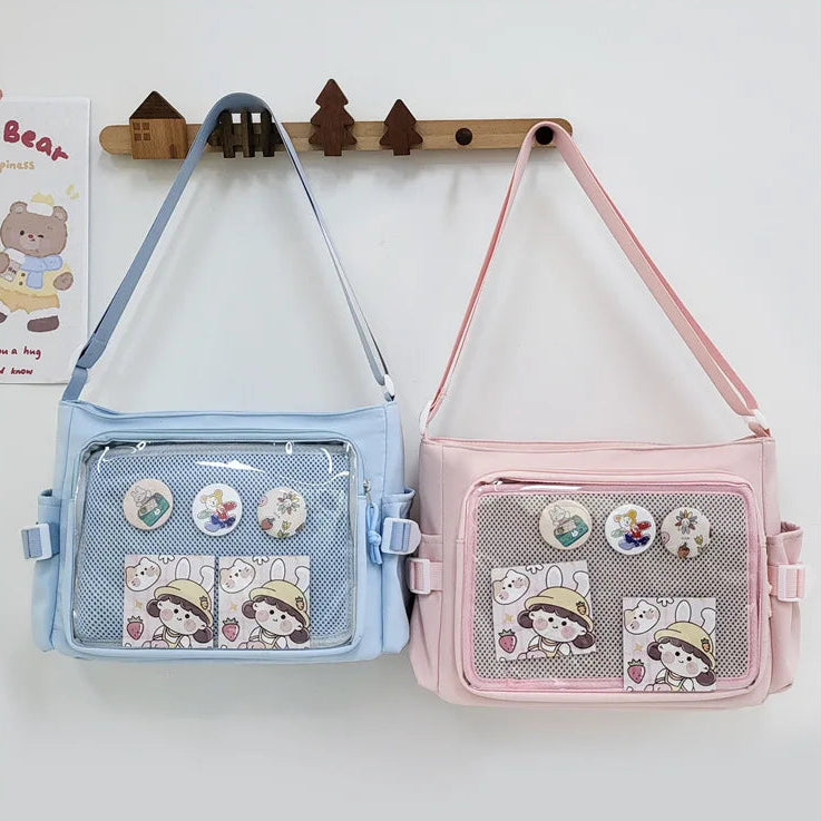 Two small bags, one blue and one pink, with Kawaii cartoon character designs on a white background.