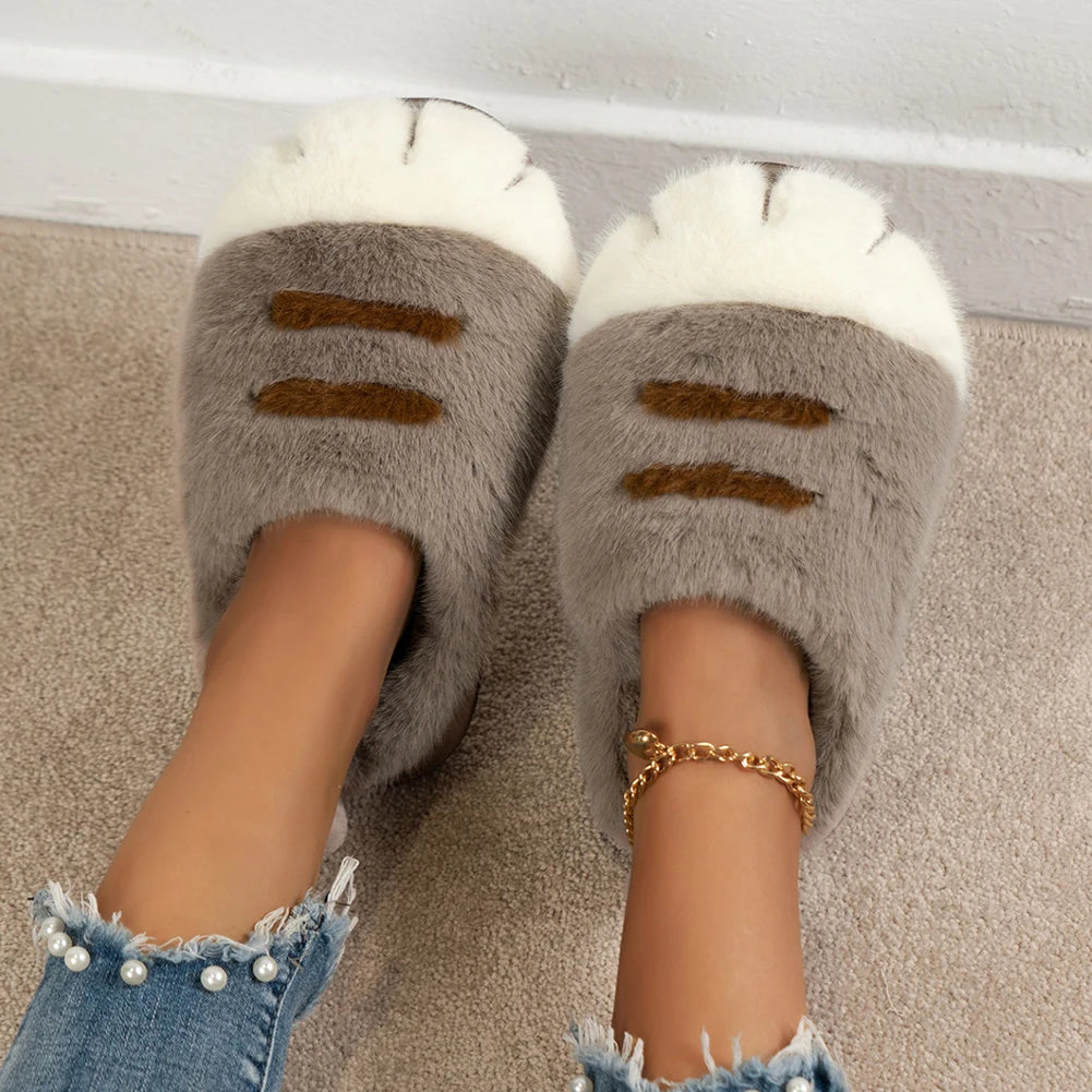 Gray fluffy kawaii slippers with white accents worn indoors on a carpeted floor.