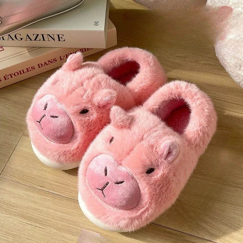 Pink pig-shaped kawaii slippers on a wooden floor with books in the background.