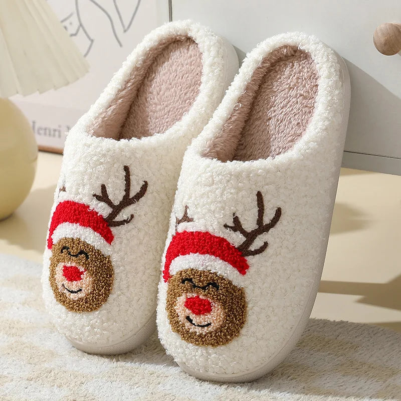 Pair of white slippers with kawaii reindeer faces on a soft surface