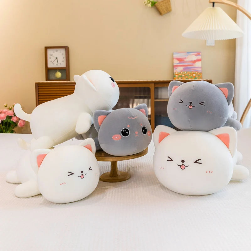 Set of cute kawaii plush toys resembling cats and a dog on a light-colored surface with a neutral background.