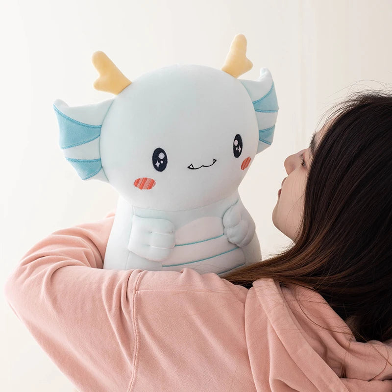 Person holding a cute kawaii plush axolotl toy against a light background