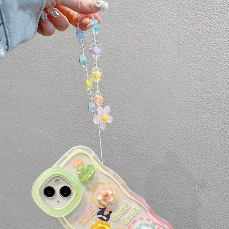 Phone case with kawaii colorful beaded chain held by a hand against a gray background