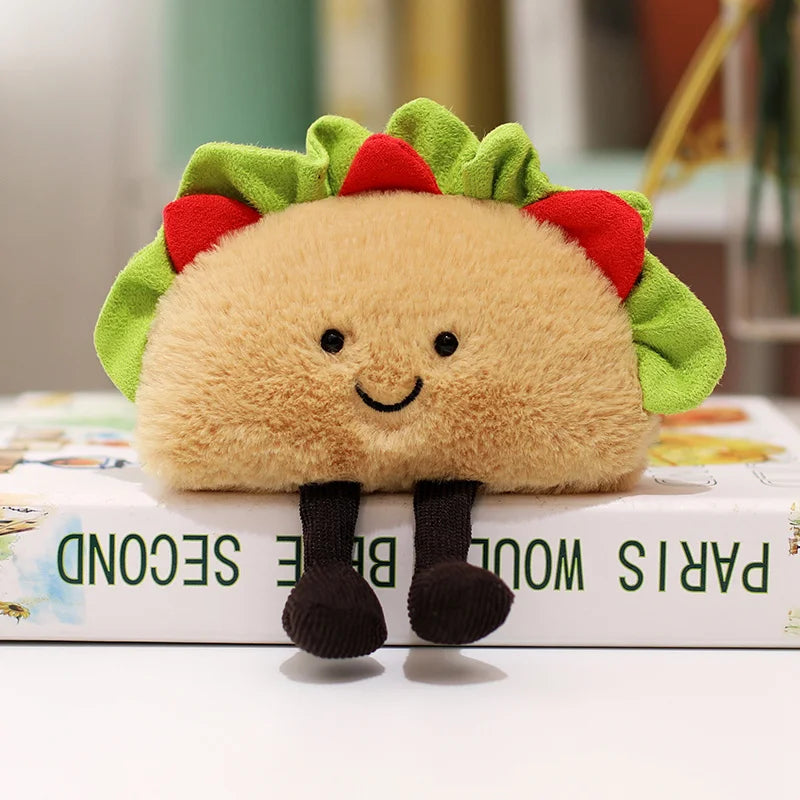 Plush kawaii toy resembling a taco with a smiling face on top of a book
