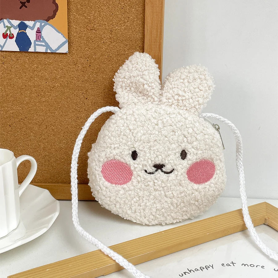White fluffy Kawaii bunny-shaped pouch with pink cheeks on a white surface.
