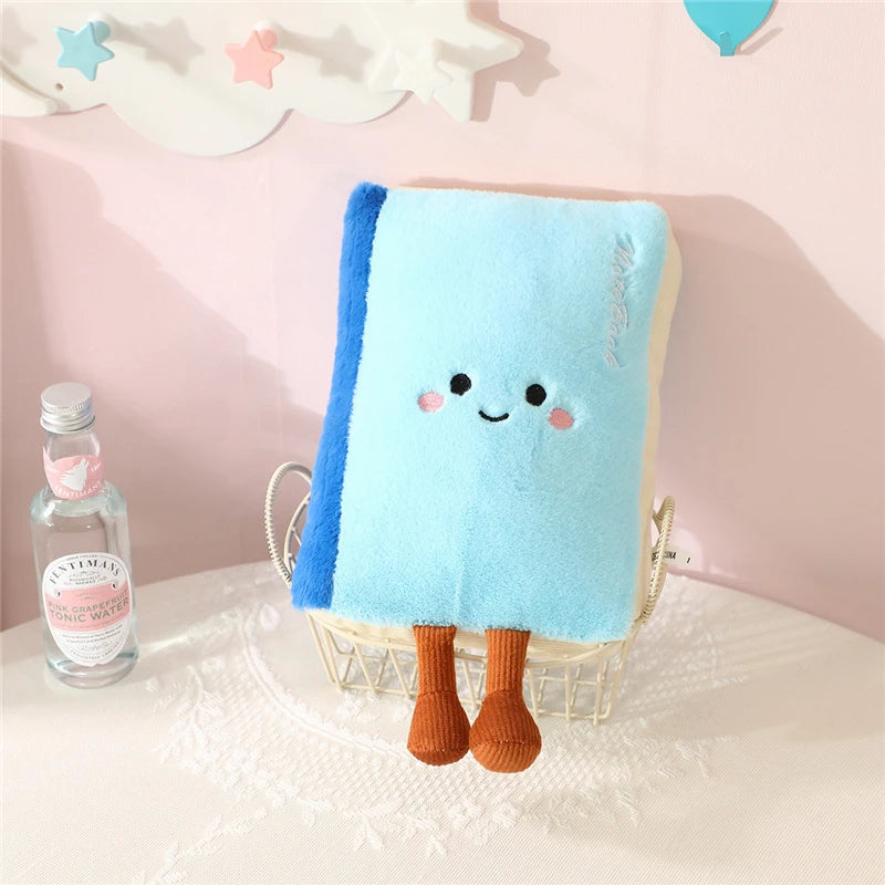 Blue kawaii plush towel with cartoon face and legs on a pink surface