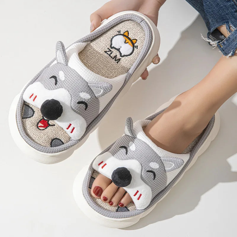 Pair of kawaii cartoon cat slippers with a visible brand logo on a light background