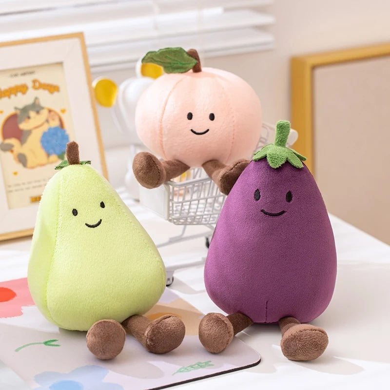 Three kawaii plush toys shaped like a pear, peach, and eggplant on a surface with a light background.