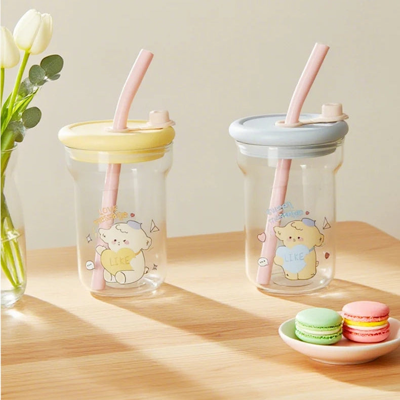 Two clear jars with Kawaii cartoon characters, colorful lids, and straws on a wooden surface.