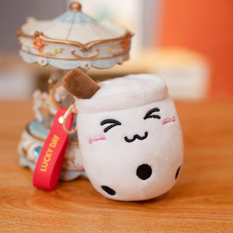 Kawaii plush toy with a face on a wooden surface with a carousel in the background