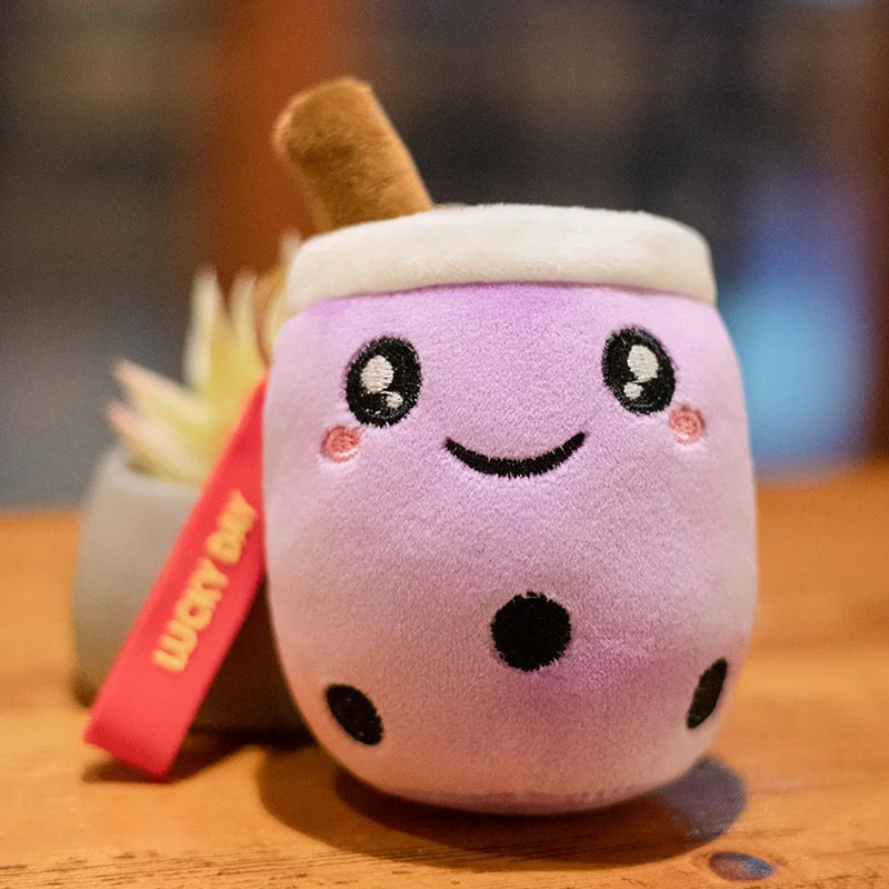 Kawaii plush toy resembling a purple bubble tea with a smiling face on a wooden surface.