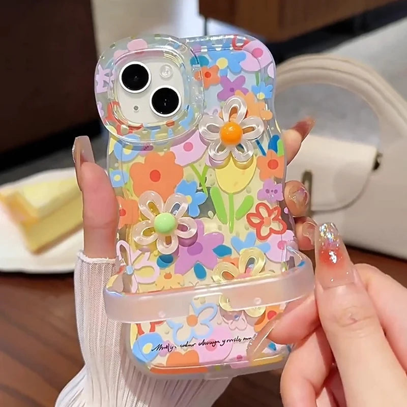 Colorful kawaii floral phone case held by a person with a blurred background