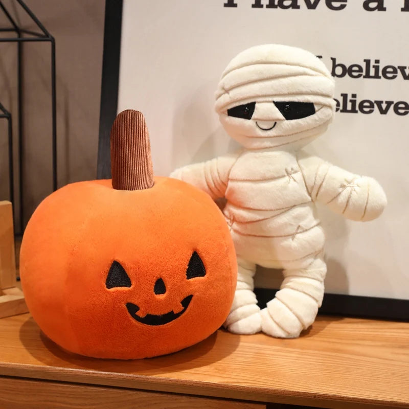 Kawaii plush mummy and pumpkin on a wooden surface with a neutral background