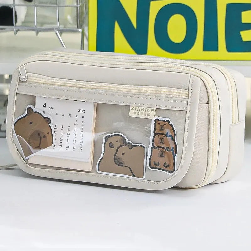 White pouch with kawaii bear designs and a calendar, placed on a white surface with a sign in the background.