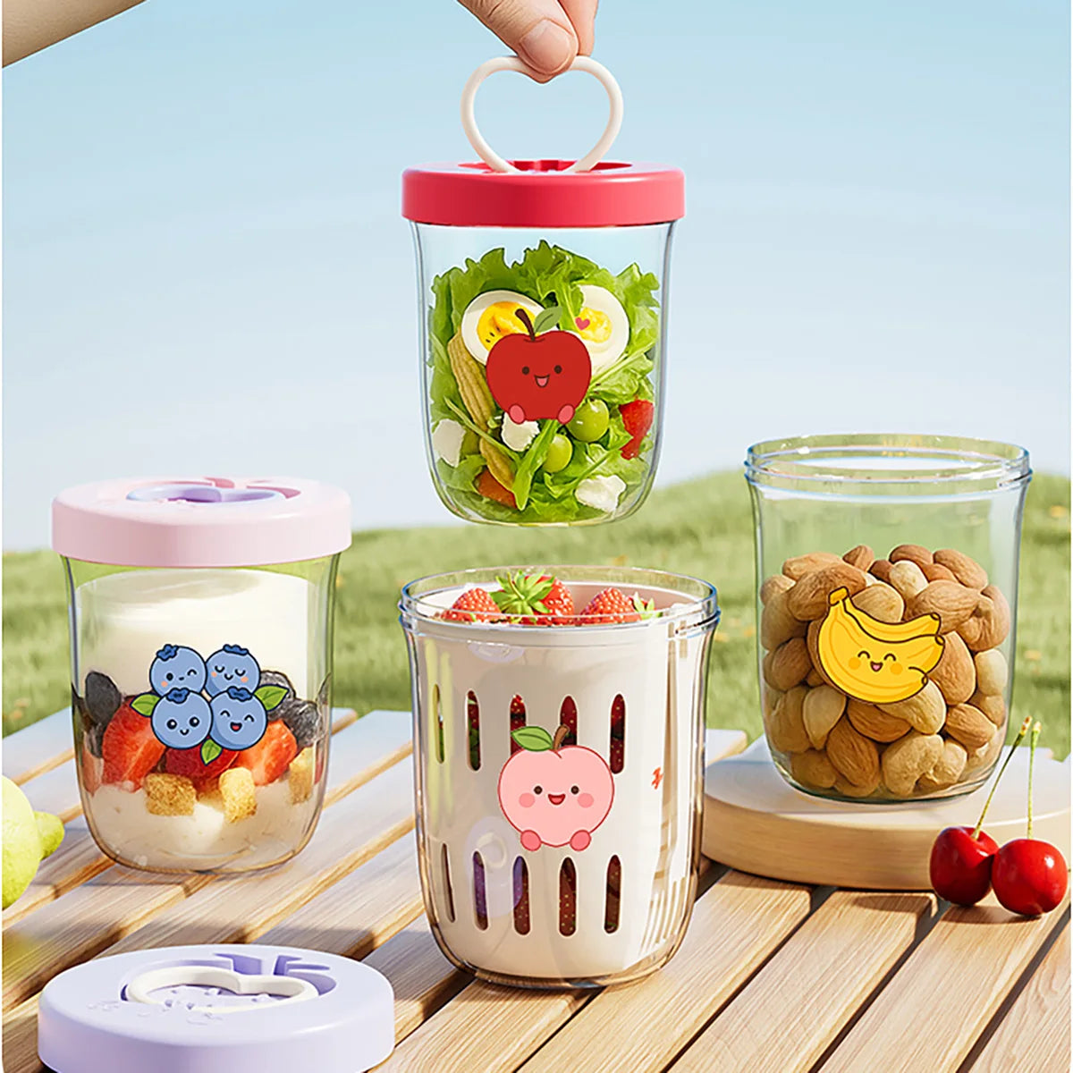 Set of transparent containers with Kawaii colorful lids filled with snacks on a wooden surface outdoors.