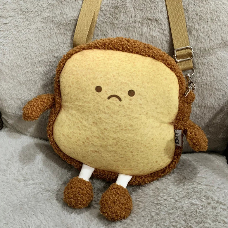 Kawaii plush toy designed like a sandwich with a sad face on a gray background