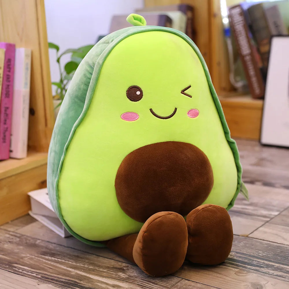 Plush avocado kawaii toy with a smiling face on a wooden surface