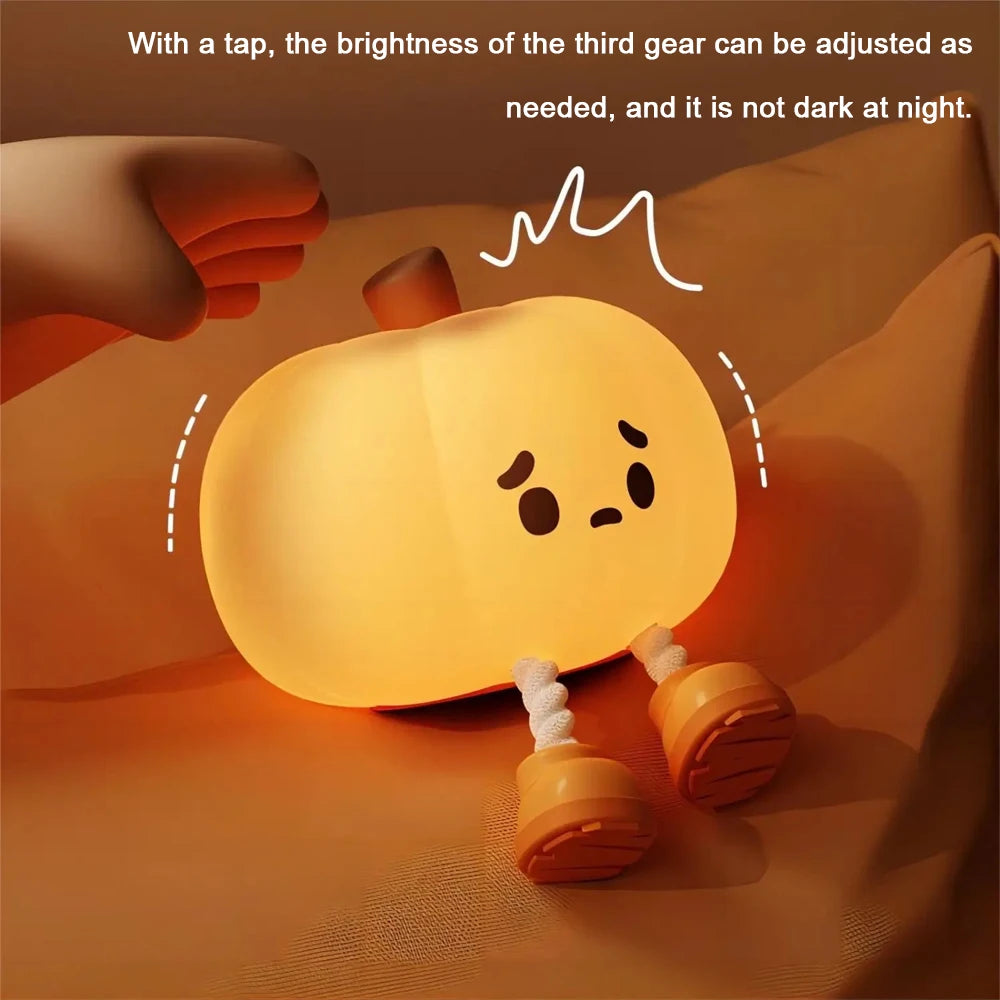 Kawaii pumpkin with a light-up face on a soft surface, showing text about brightness adjustment.