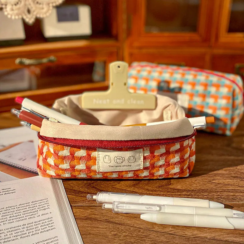 Patterned kawaii pencil case on a desk with pens and a book