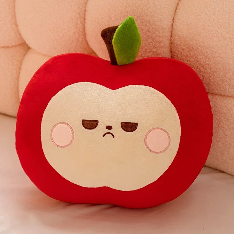 Plush kawaii toy shaped like a red apple with a sad face on a soft pink background