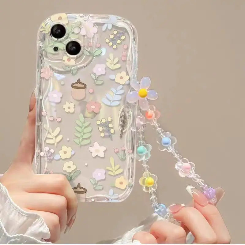 Phone case with floral kawaii design and chain holder held by a hand
