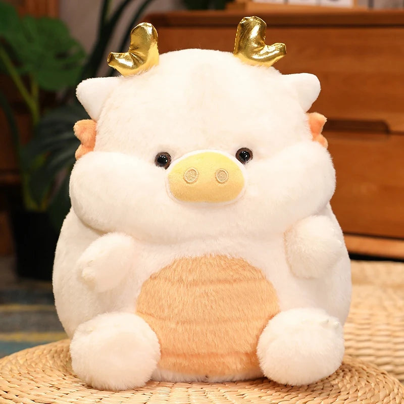 Kawaii plush toy cow with gold horns on a woven mat