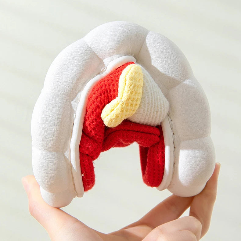 Toy model of a kawaii dog's digestive system held by a hand against a white background