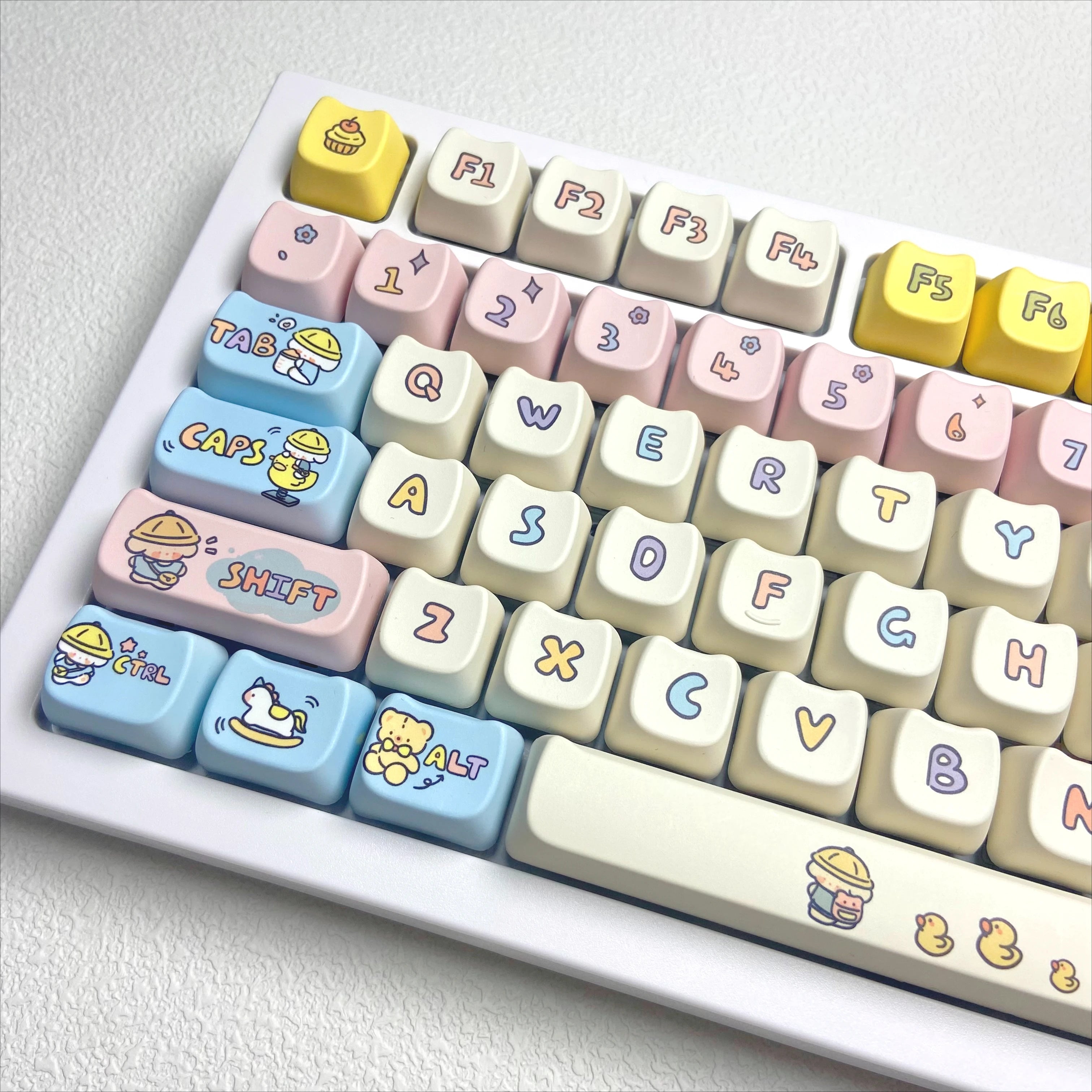 Colorful keyboard with Kawaii cartoon character keycaps on a white background