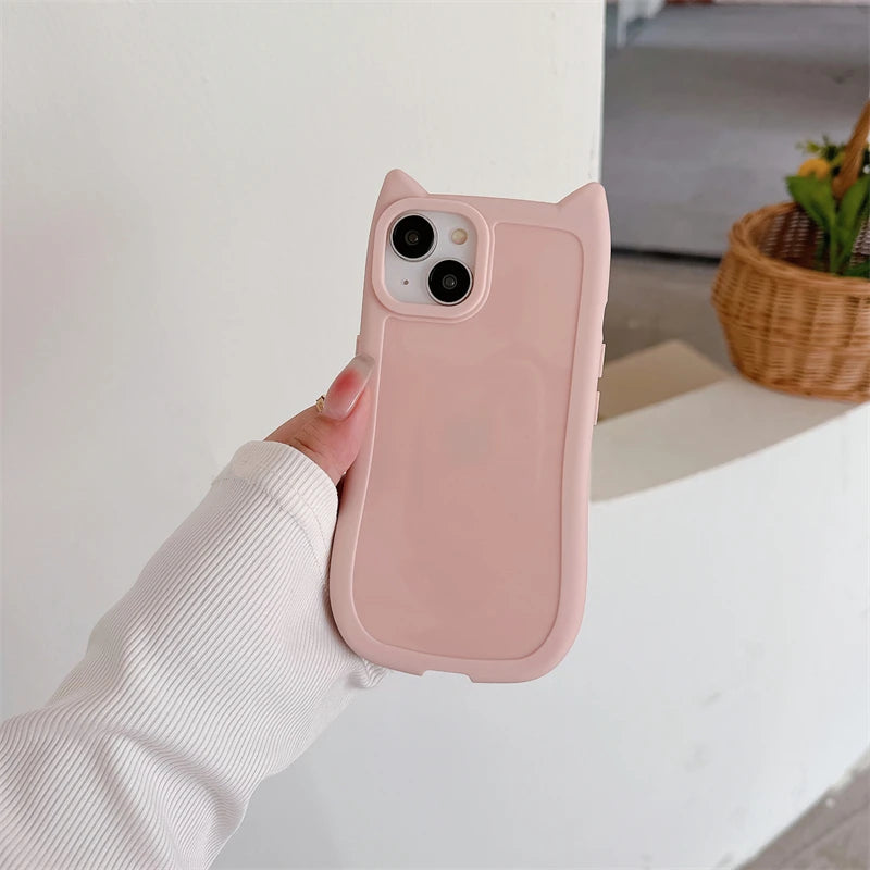 Pink kawaii phone case held by a hand with a neutral background