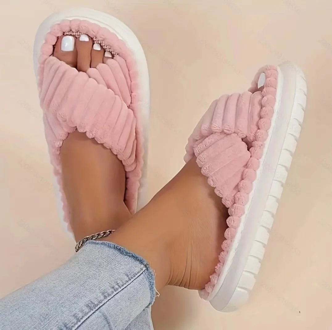 Pink kawaii slippers worn with a blurred background