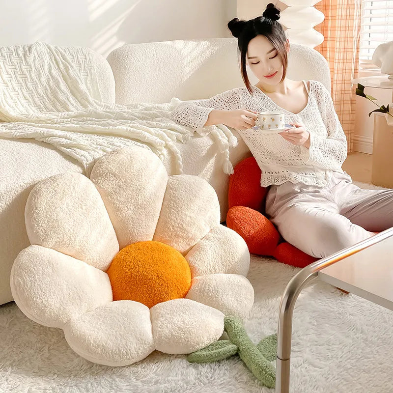 Woman sitting on a couch with a large Kawaii flower-shaped pillow in a cozy room.