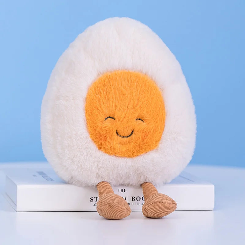 Plush toy shaped like a smiley kawaii face egg on books with a blue background