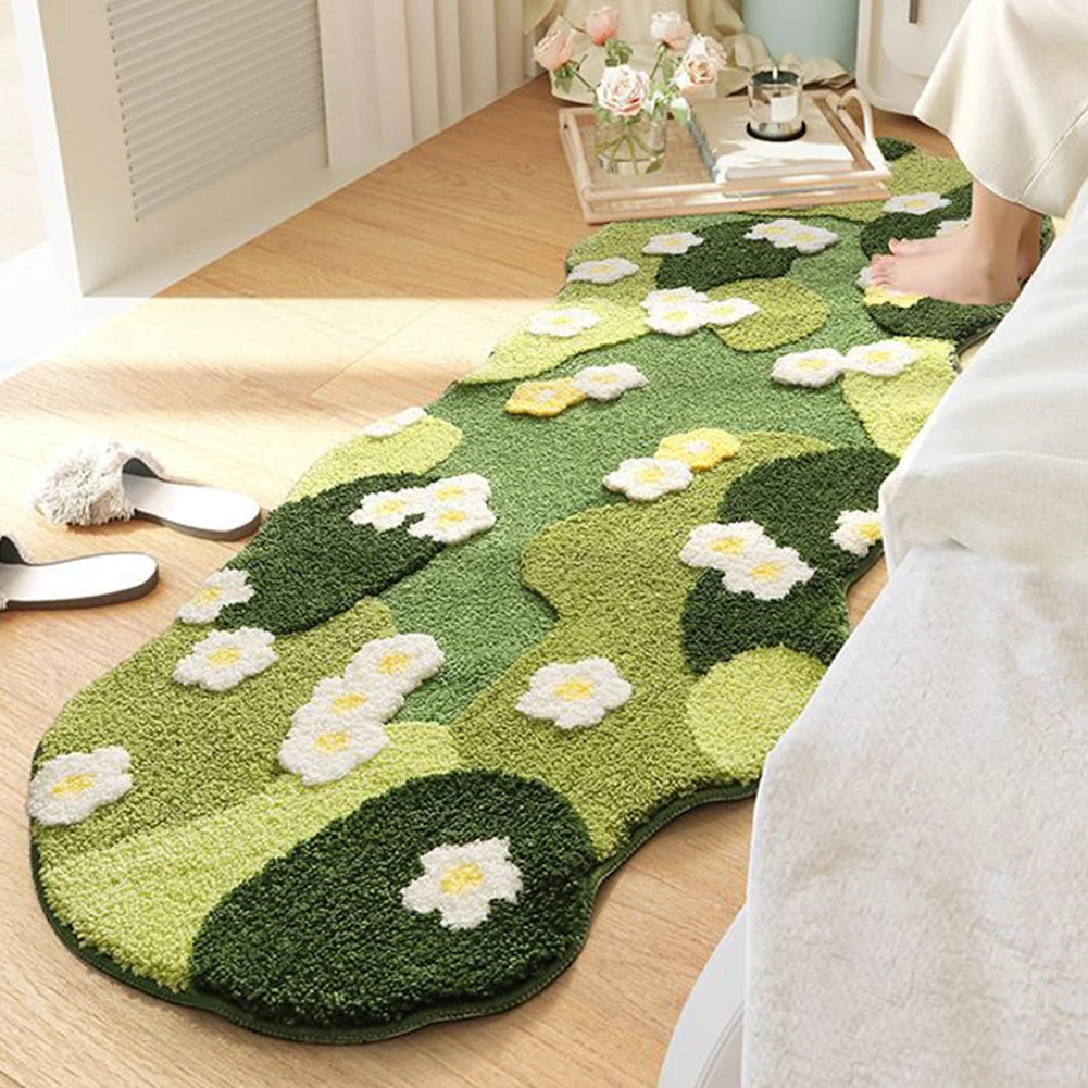 Green kawaii floral-patterned rug on a wooden floor with a person wearing white pants.