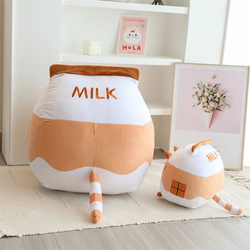 Cute kawaii plush toys shaped like milk cartons on a light wooden floor.