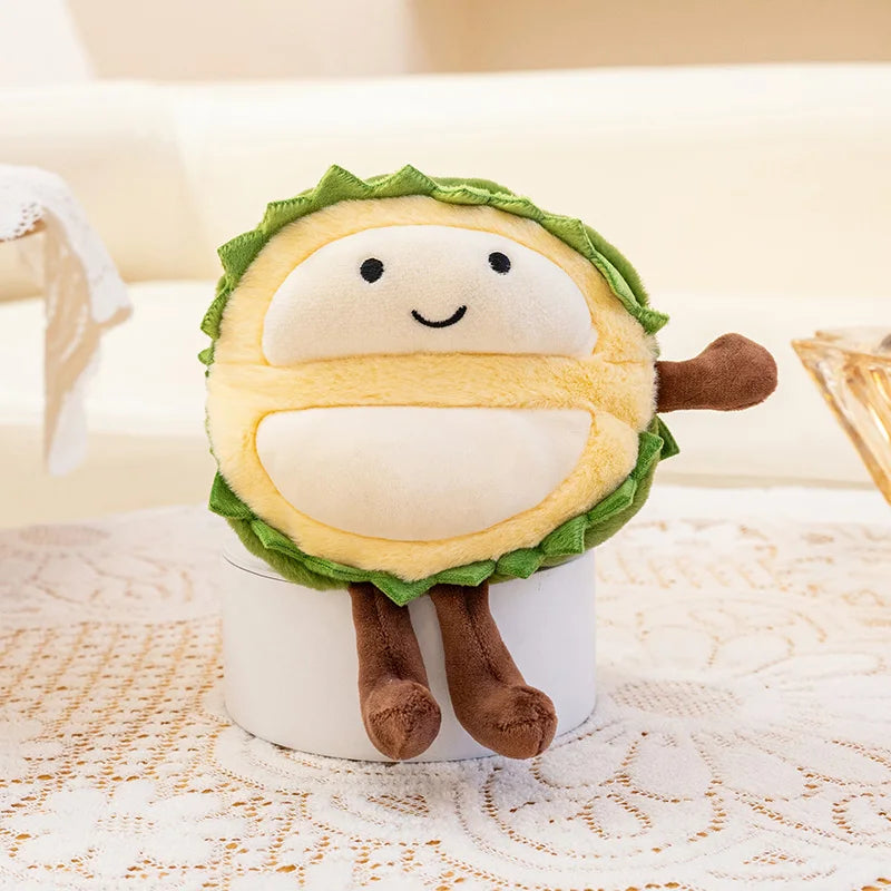 Plush kawaii toy resembling a character with a face, green leaves, and brown stem on a white surface.