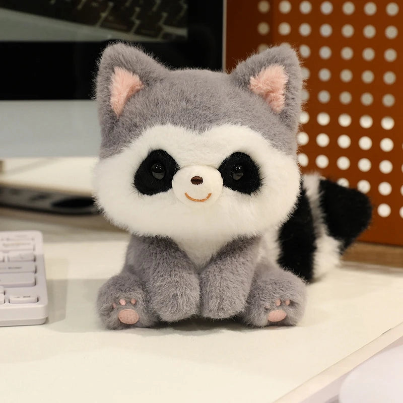 Plush kawaii toy raccoon on a desk with office equipment in the background