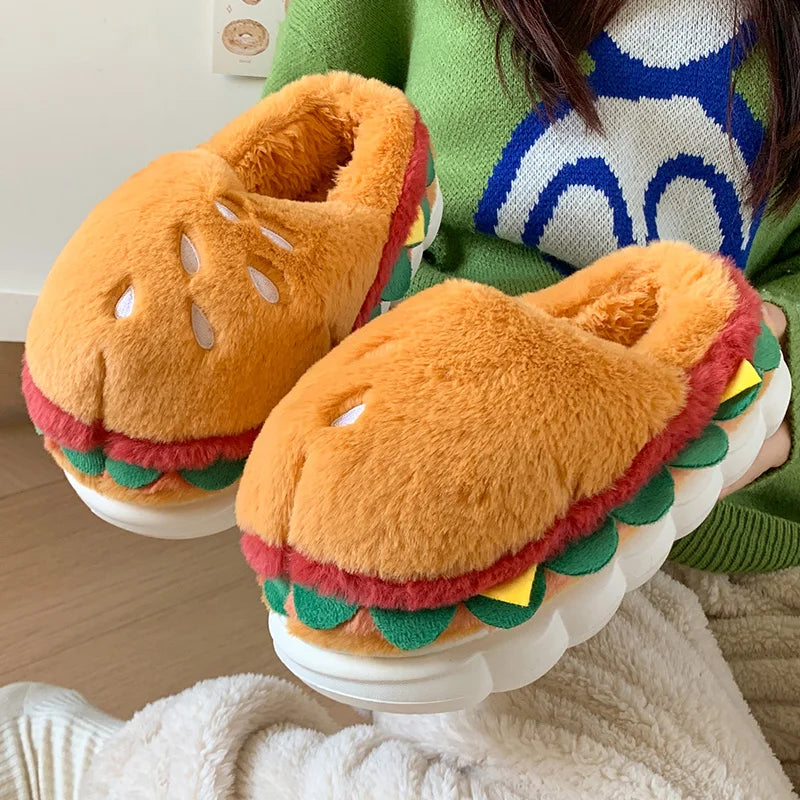 Hamburger-shaped kawaii slippers worn by a person in a green sweater with a colorful pattern.