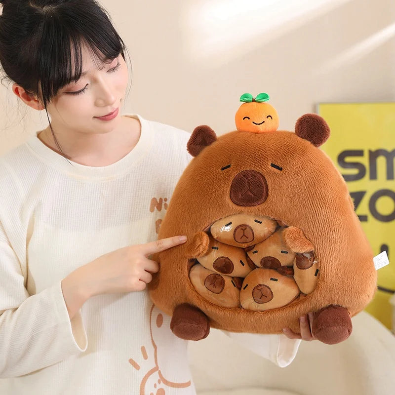 Person holding a kawaii plush toy resembling a bear with a small orange creature on its head.