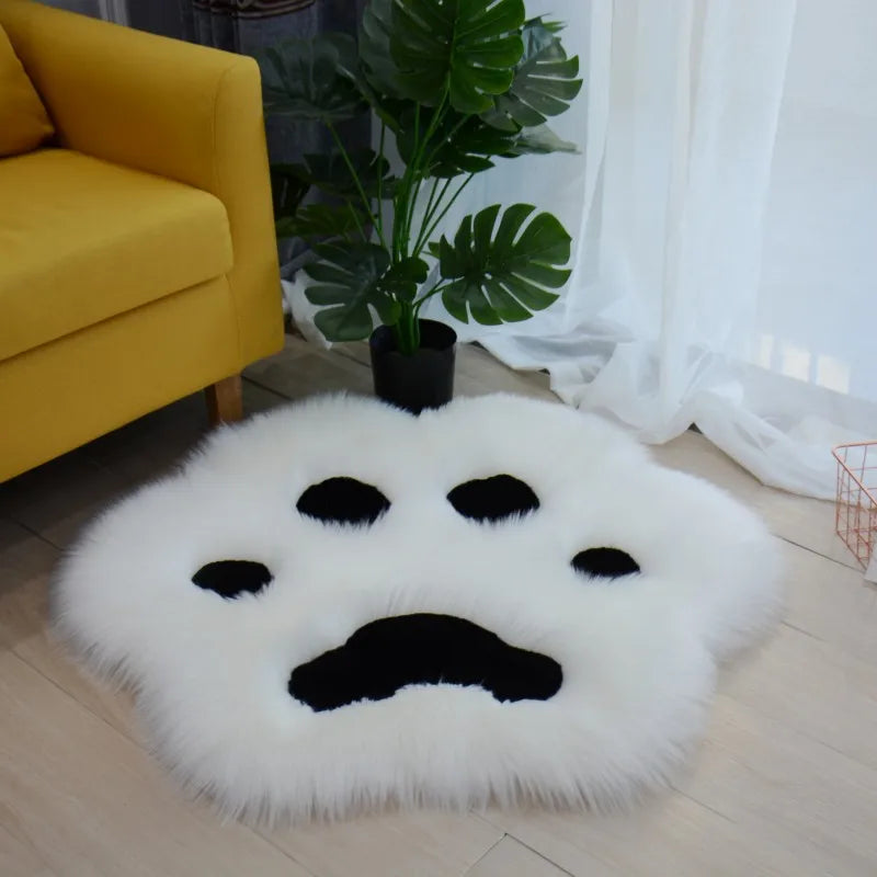 Round white kawaii rug with black paw prints in a living room setting