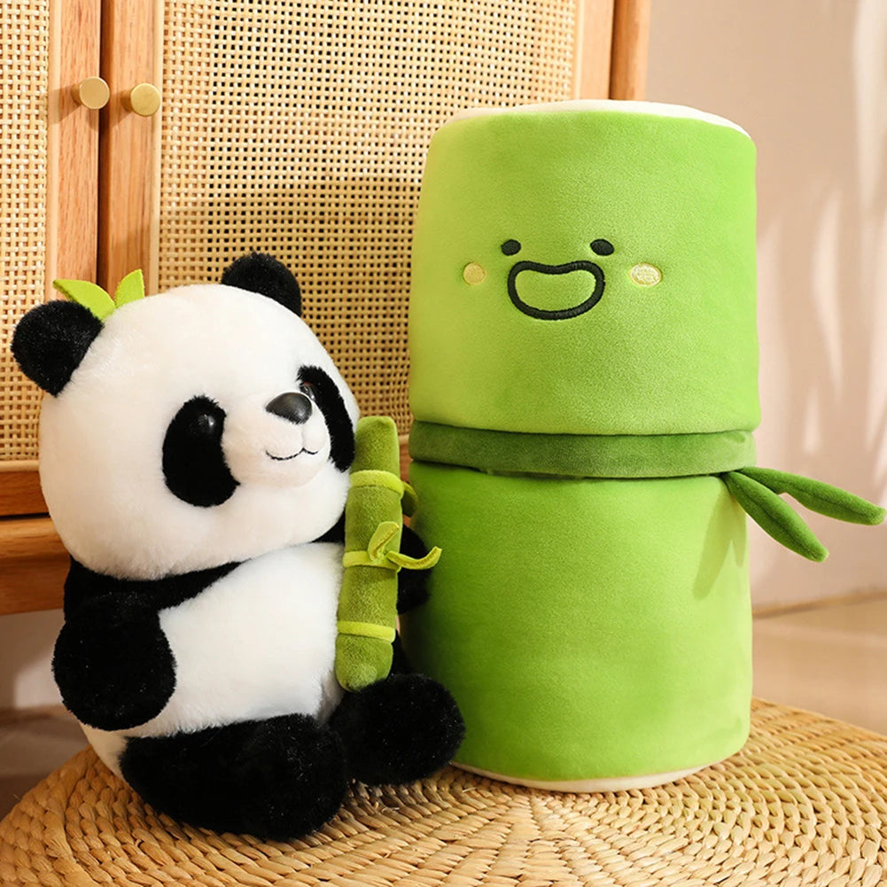 Plush kawaii panda holding a bamboo stick next to a green plush toy with a face on a woven surface.